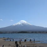Iconic Mount Fuji framed by clear skies and lush surroundings, Japan.