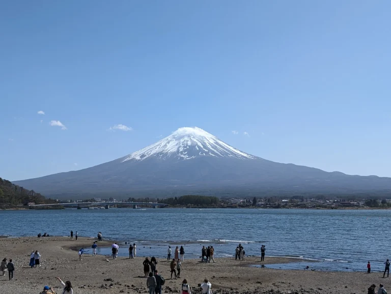 Iconic Mount Fuji framed by clear skies and lush surroundings, Japan.